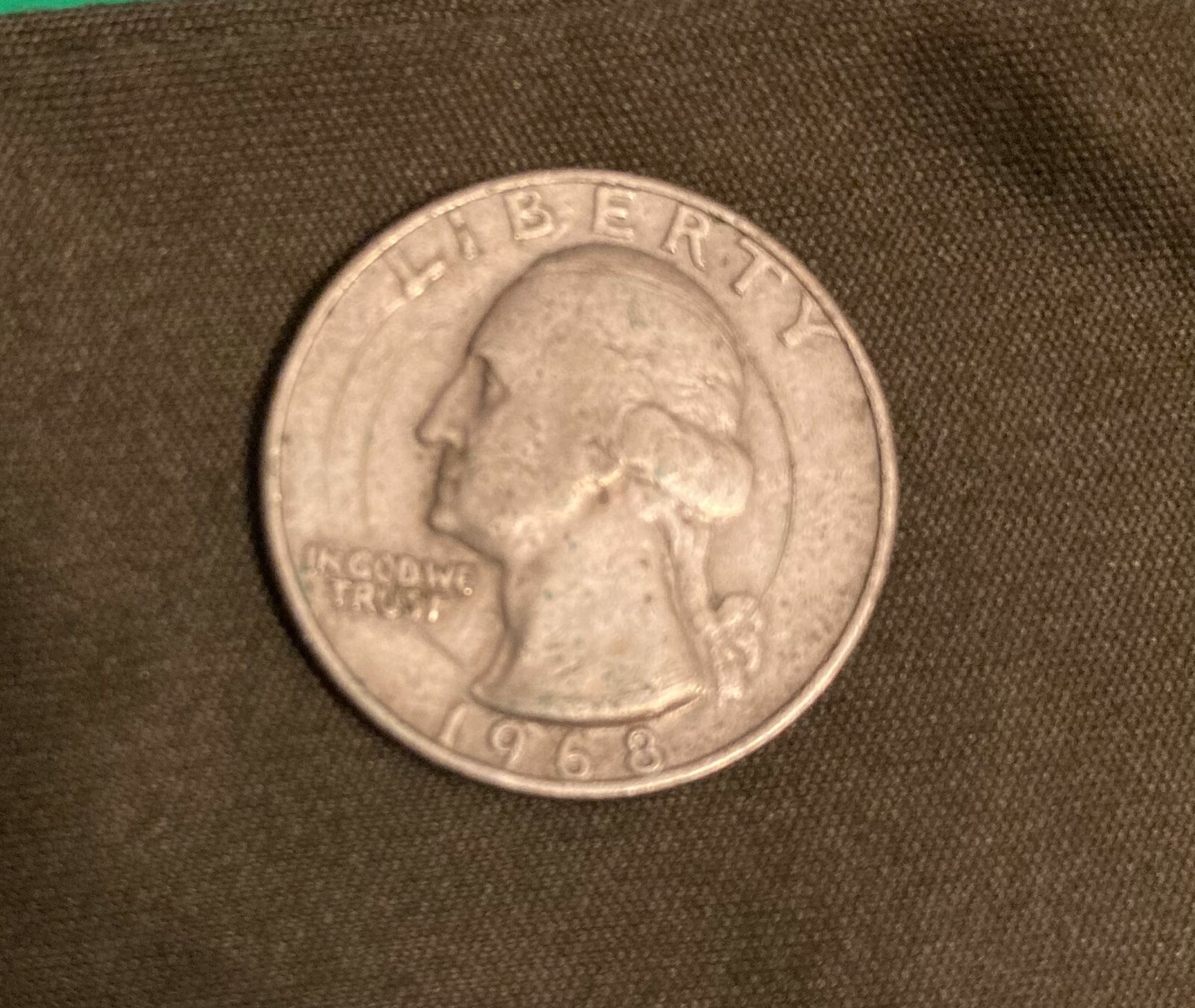 1968 quarter broadstrike error with expanded diameter and flattened rim compared to normal quarter
